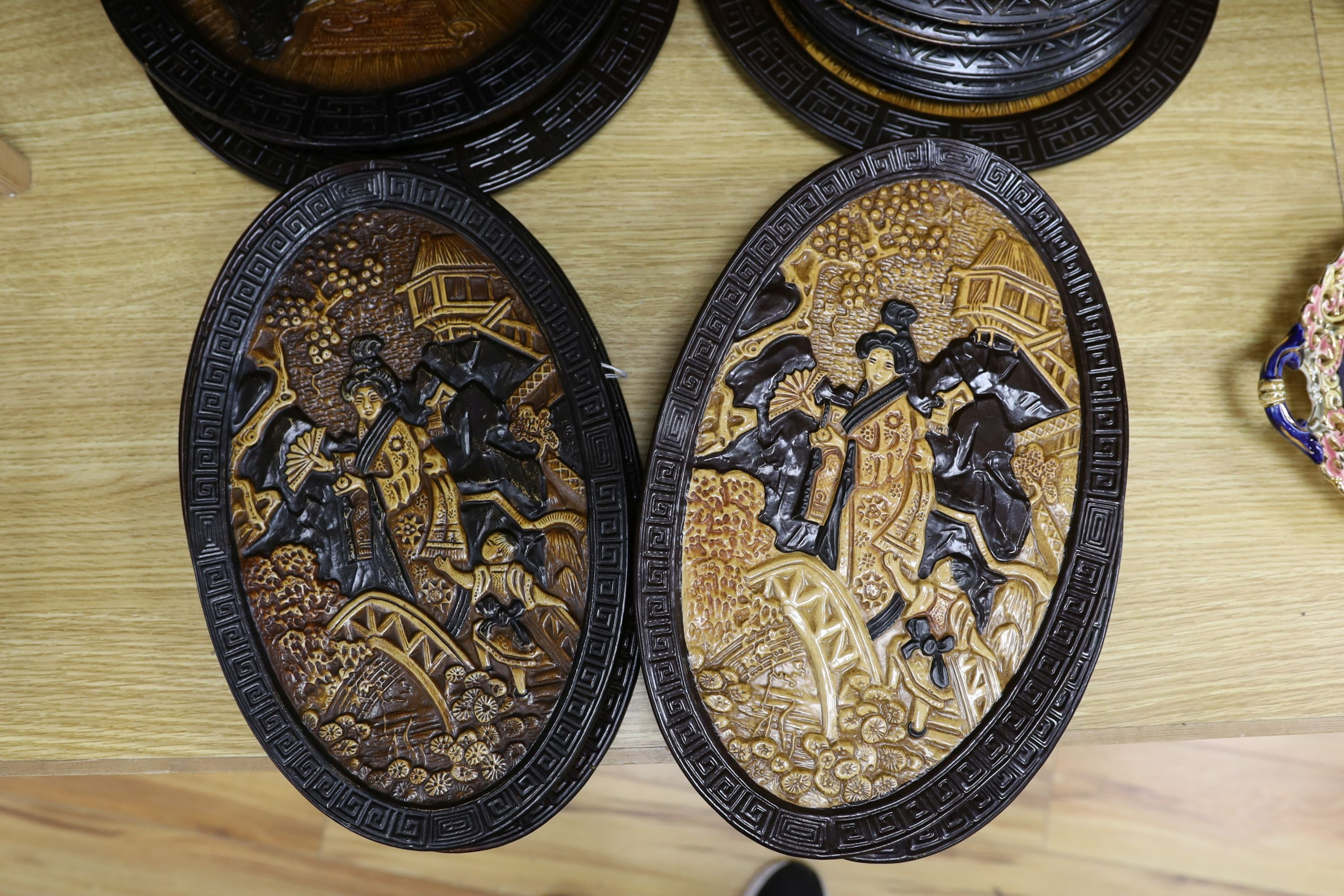 A collection of 13 Bretby chinoiserie wall plaques, largest 35cm diameter